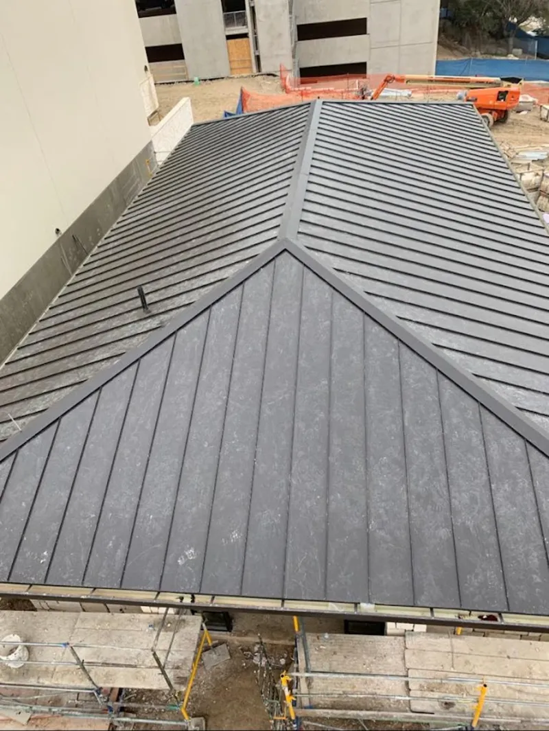 Commercial metal roof construction with crane equipment in Fishkill